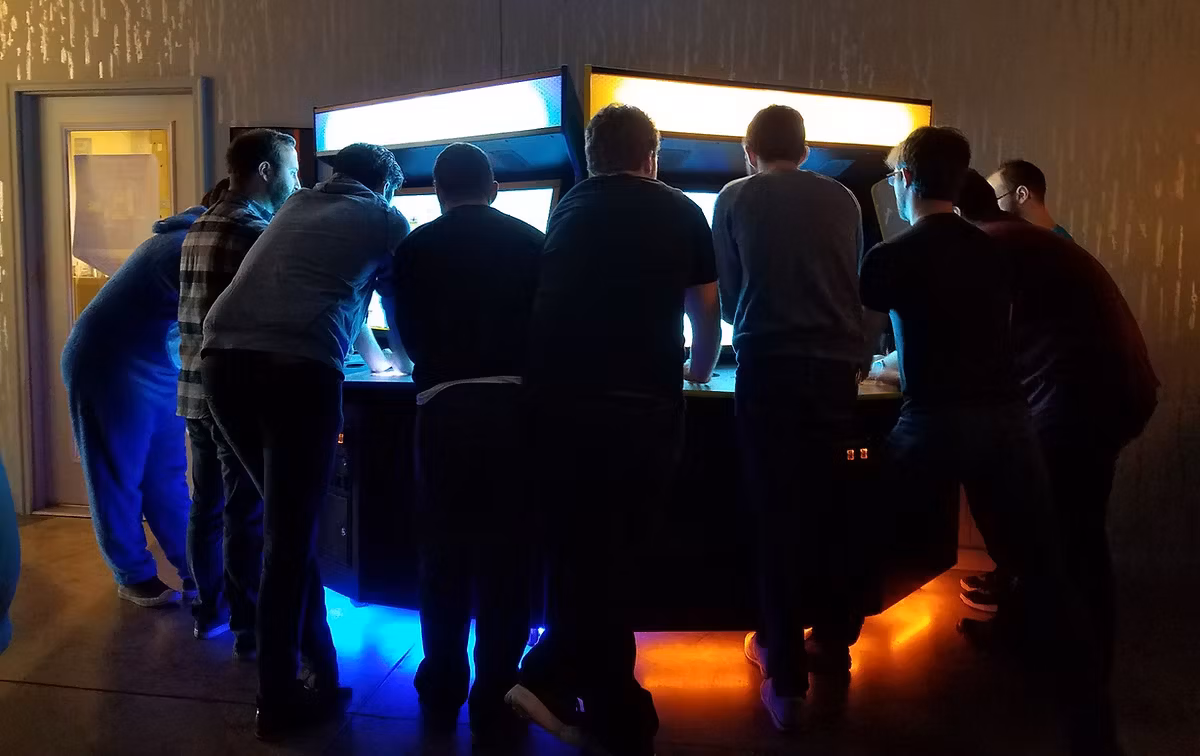 Players gathered around a Killer Queen cabinet